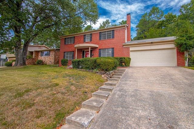 colonial house featuring driveway, brick siding, a chimney, and a front yard