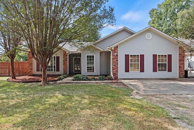 ranch-style home featuring a front lawn and a patio area