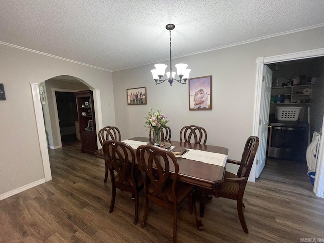 dining space with dark wood-type flooring, a chandelier, crown molding, and a textured ceiling