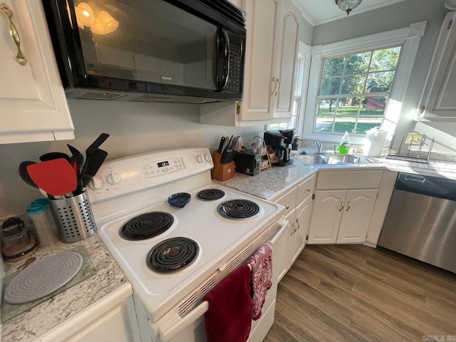 kitchen with stainless steel dishwasher, sink, hardwood / wood-style flooring, white cabinetry, and white range with electric stovetop