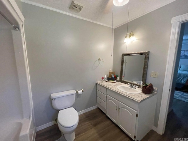 bathroom with hardwood / wood-style floors, toilet, ornamental molding, and vanity