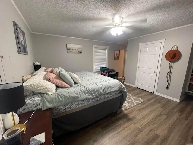 bedroom with crown molding, ceiling fan, and dark hardwood / wood-style flooring