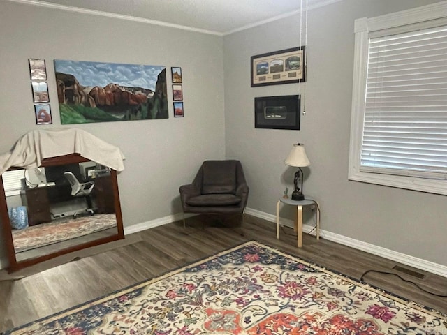 living area featuring ornamental molding and hardwood / wood-style flooring