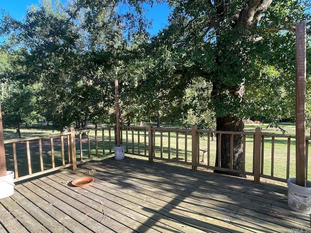 wooden deck featuring a lawn