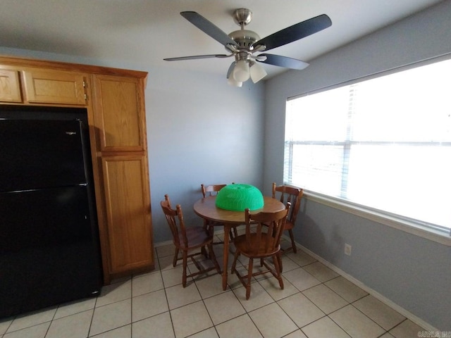 tiled dining area with ceiling fan