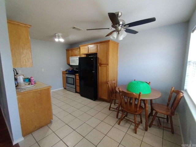 kitchen featuring ceiling fan, stainless steel electric range oven, black fridge, and light tile patterned flooring