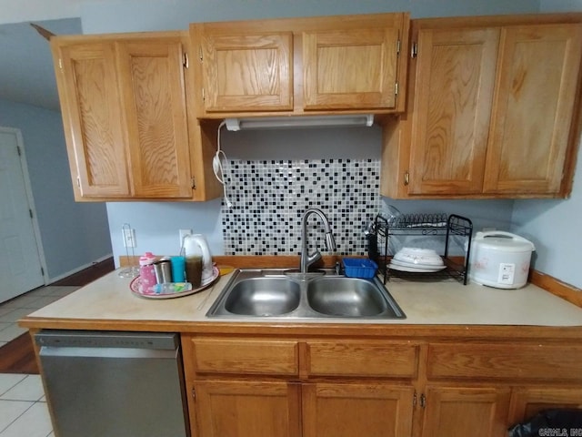 kitchen with light tile patterned floors, decorative backsplash, sink, and stainless steel dishwasher