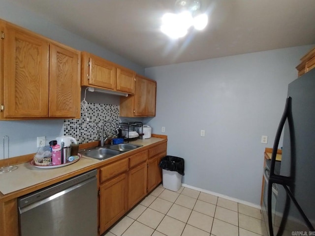 kitchen with backsplash, stainless steel dishwasher, sink, black fridge, and light tile patterned flooring