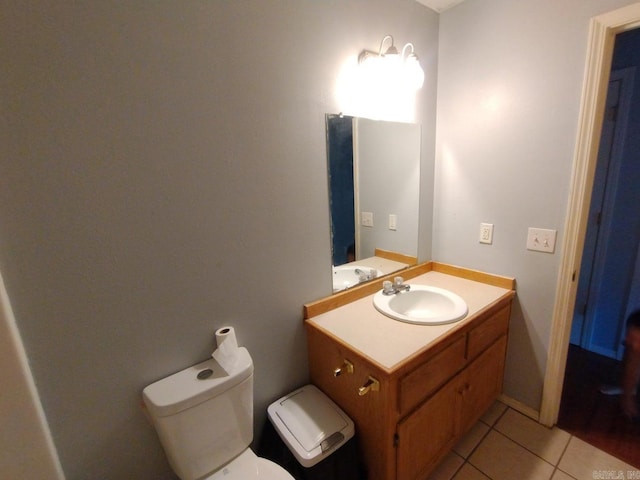 bathroom with vanity, toilet, and tile patterned floors