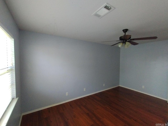 spare room featuring ceiling fan and dark hardwood / wood-style floors