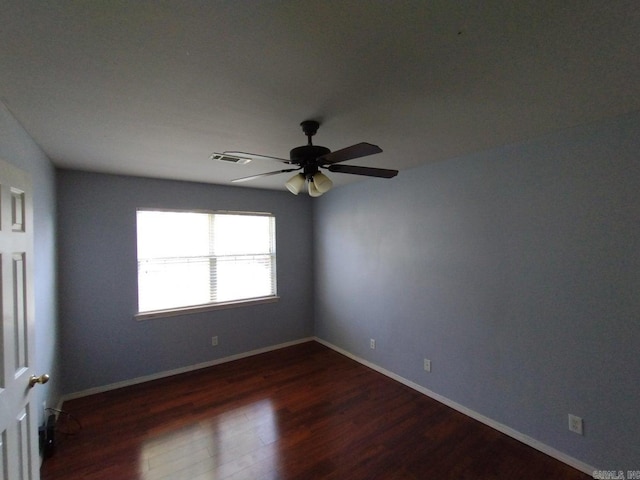 unfurnished room with ceiling fan and dark hardwood / wood-style flooring