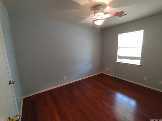 spare room with ceiling fan and dark hardwood / wood-style floors