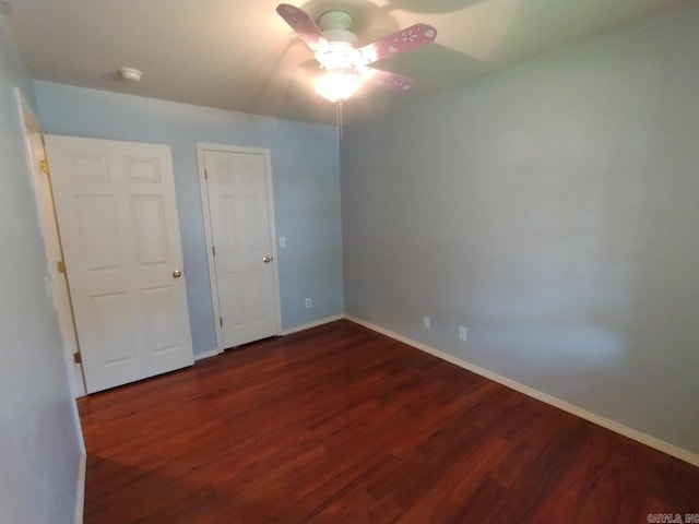 unfurnished bedroom with dark wood-type flooring and ceiling fan