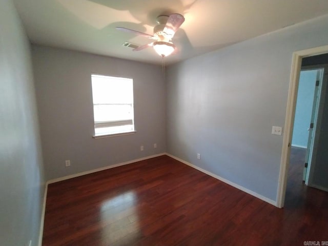 unfurnished room with dark wood-type flooring and ceiling fan