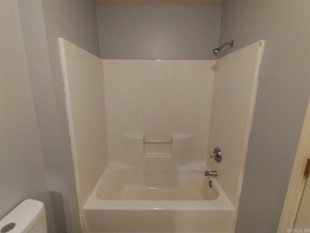 bathroom featuring shower / bathtub combination and toilet