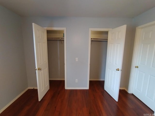 unfurnished bedroom with dark hardwood / wood-style flooring