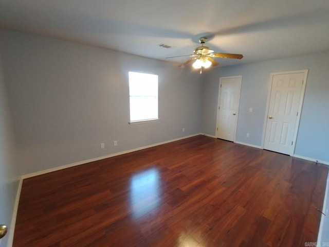 spare room with ceiling fan and dark hardwood / wood-style floors