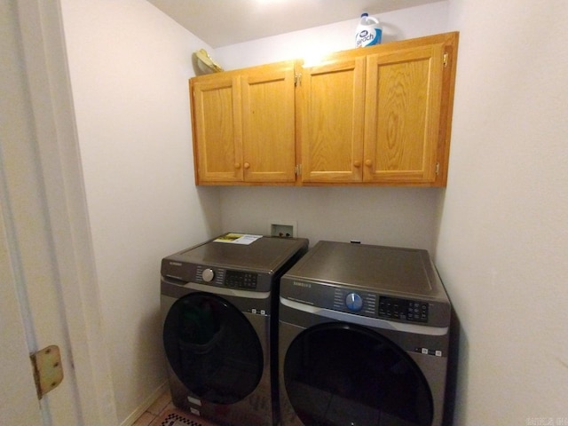 laundry room with cabinets and washing machine and dryer