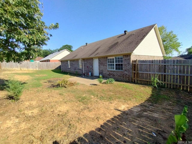 rear view of property with a lawn