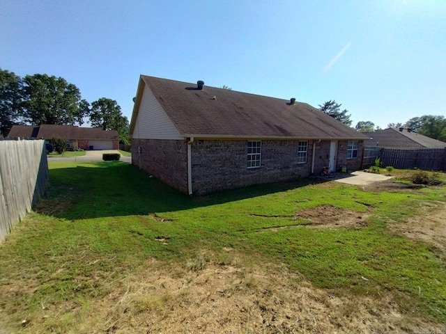 rear view of house with a yard