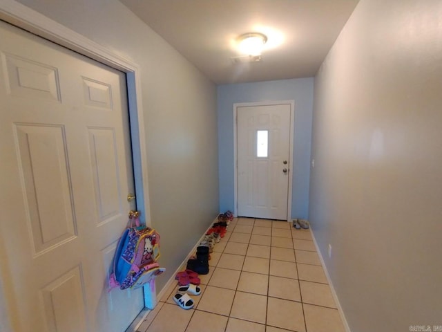 entryway with light tile patterned flooring