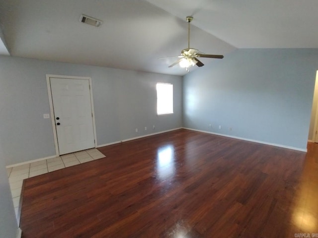 empty room featuring ceiling fan, wood-type flooring, and vaulted ceiling