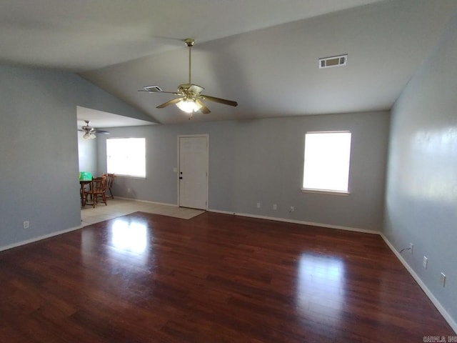 spare room with lofted ceiling, ceiling fan, and dark hardwood / wood-style flooring