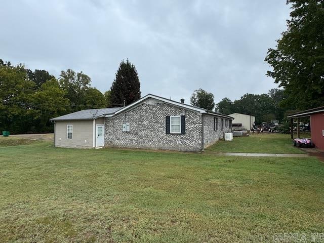 view of side of property with a lawn