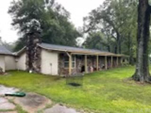 rear view of property with a lawn