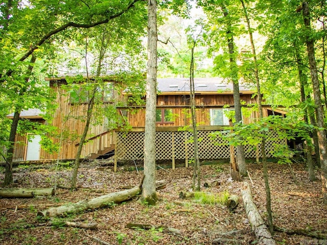 rear view of property featuring a deck