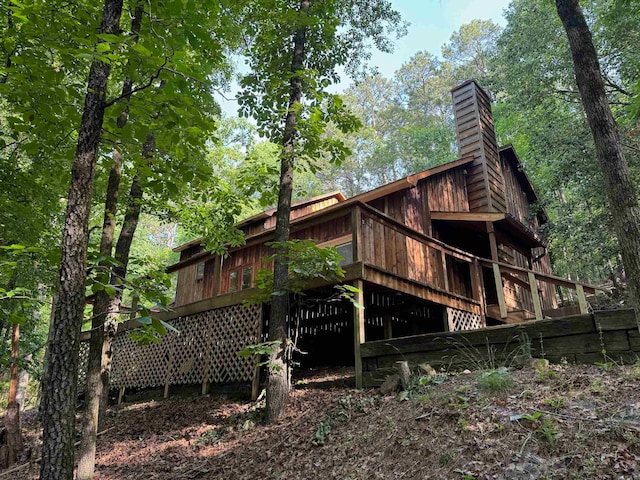 view of property exterior with a deck