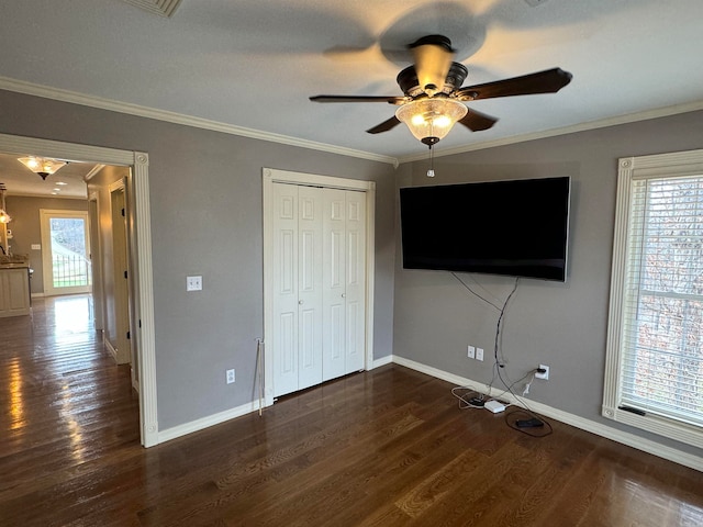 unfurnished bedroom featuring ceiling fan, ornamental molding, a closet, and dark hardwood / wood-style flooring