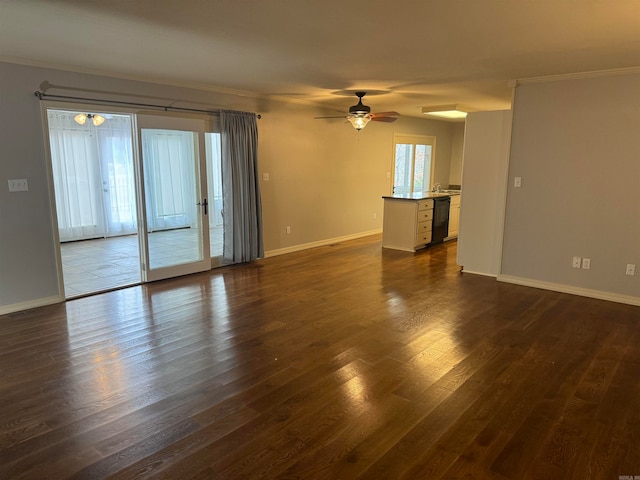 empty room with crown molding, ceiling fan, and dark hardwood / wood-style flooring