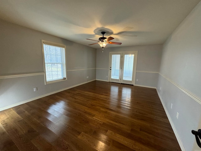 empty room with dark wood-type flooring and ceiling fan