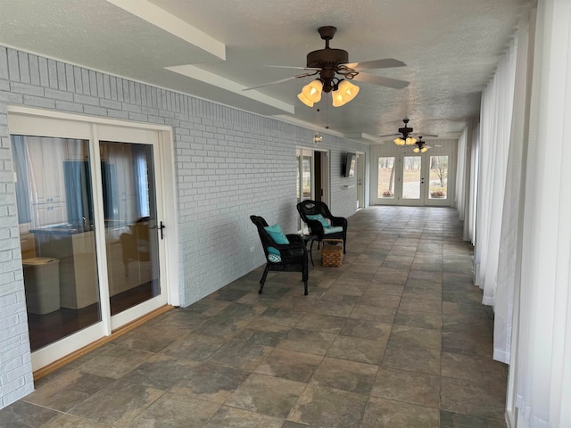 interior space with french doors and ceiling fan