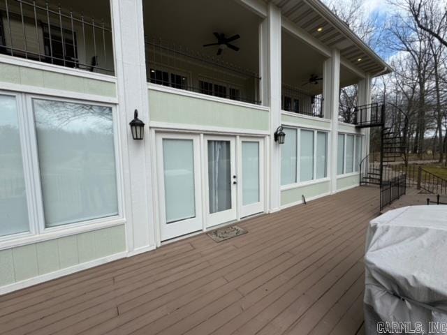 deck with a grill and ceiling fan