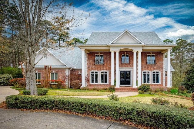 neoclassical home with a front lawn