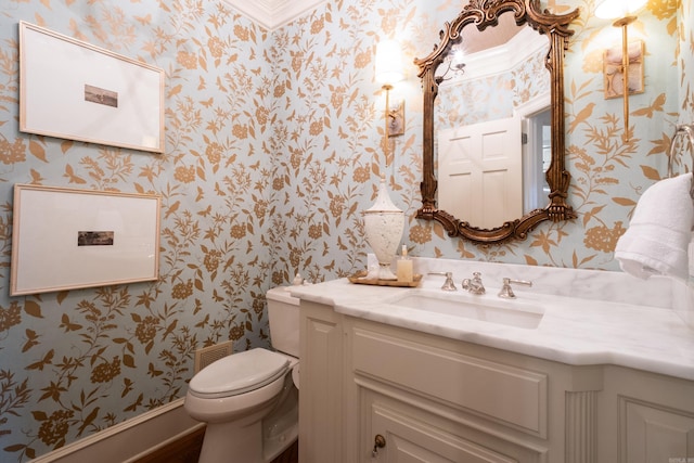 bathroom featuring toilet and vanity