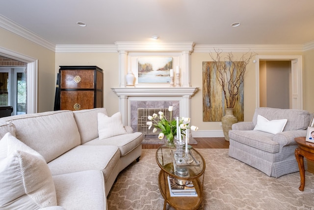 living room with hardwood / wood-style flooring, a fireplace, and ornamental molding