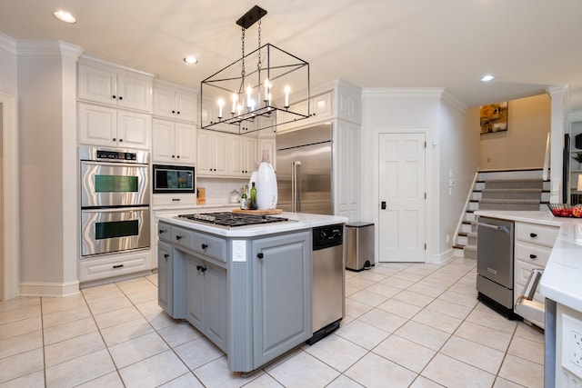 kitchen featuring white cabinetry, crown molding, built in appliances, and a kitchen island