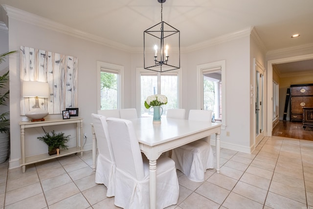 dining space with light wood-type flooring, an inviting chandelier, and crown molding