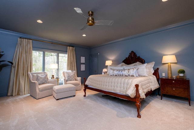 bedroom with ornamental molding, light colored carpet, and ceiling fan