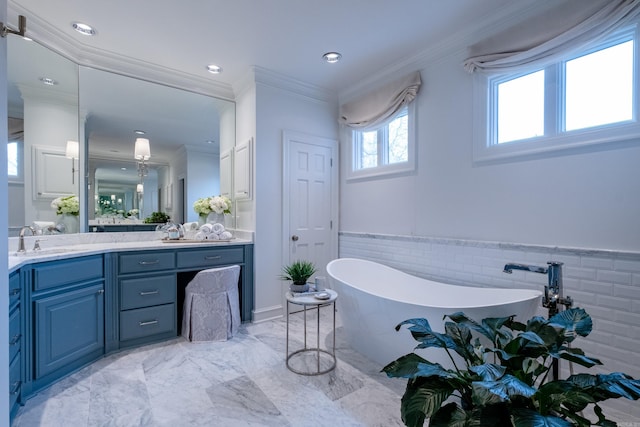 bathroom with a washtub, ornamental molding, and vanity