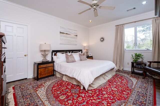 bedroom with ceiling fan, hardwood / wood-style flooring, and ornamental molding