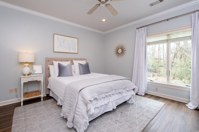 bedroom with crown molding, hardwood / wood-style floors, and ceiling fan