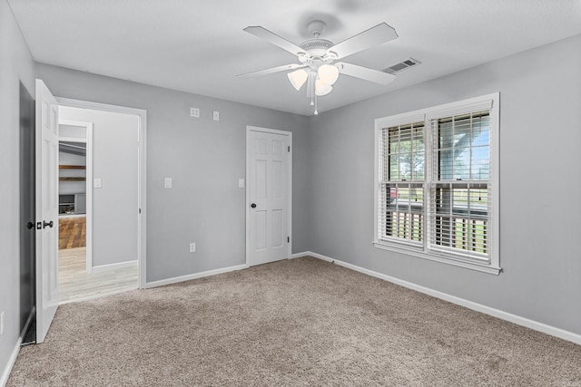 unfurnished bedroom featuring carpet and ceiling fan