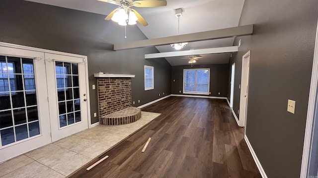 interior space featuring baseboards, lofted ceiling, and wood finished floors