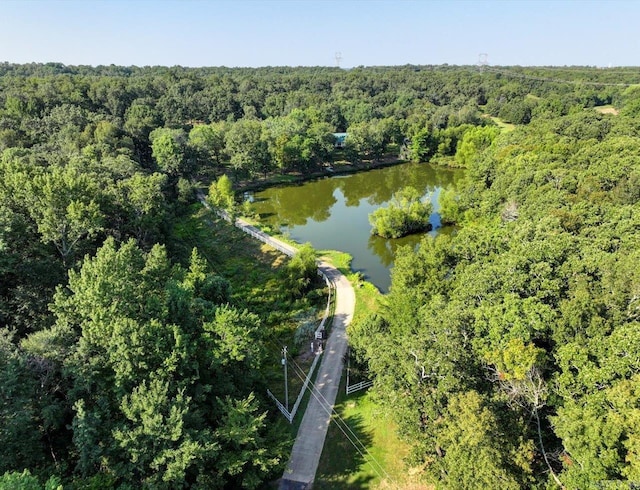 aerial view featuring a view of trees and a water view