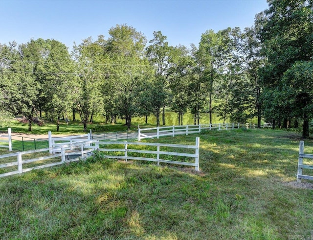 view of yard with a rural view and fence