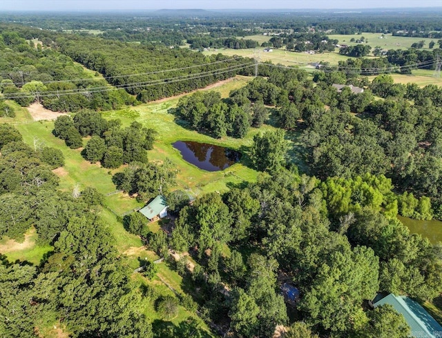 aerial view featuring a forest view and a water view